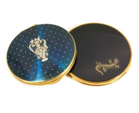 POWDER COMPACTS.A Vogue Vanities powder compact, the lid with silver & marcasite lizard, diameter 8.5cm. Also, a Kigu gold to
