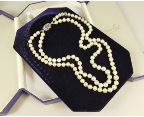 CULTURED PEARLS. A twin strand cultured pearl necklace, with 18ct. white gold diamond &amp; sapphire set clasp. In fitted Mar