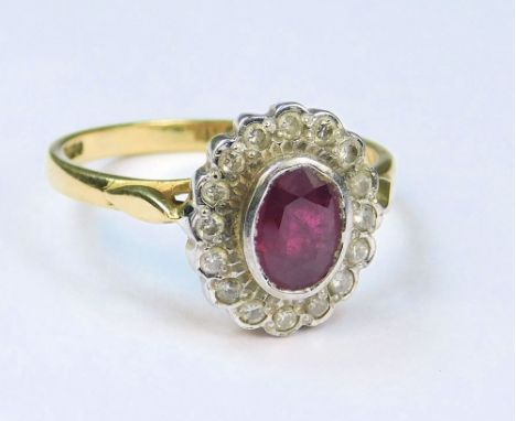 GOLD RING. An 18ct. gold ruby &amp; diamond cluster ring. Setting 12 x 11mm. (P).