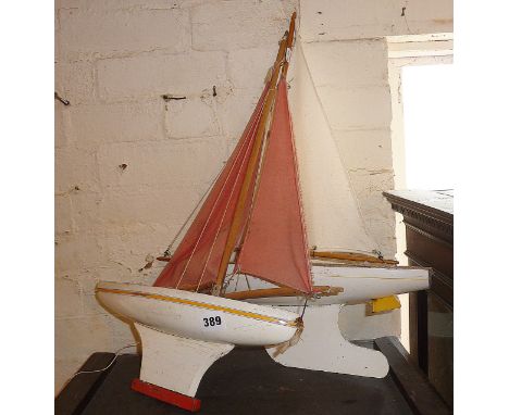 Two vintage painted wooden toy pond yachts, one labelled as Star Yacht