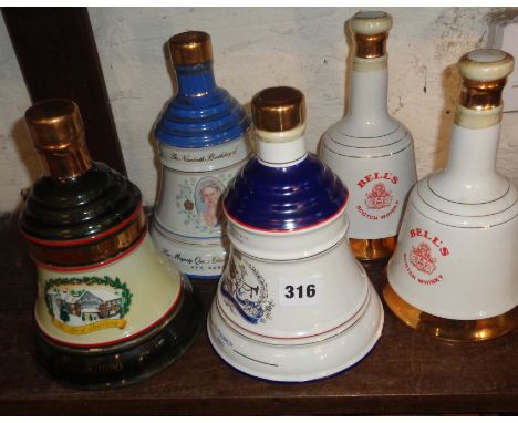 Five Wade china decanters full of Bell's Whisky