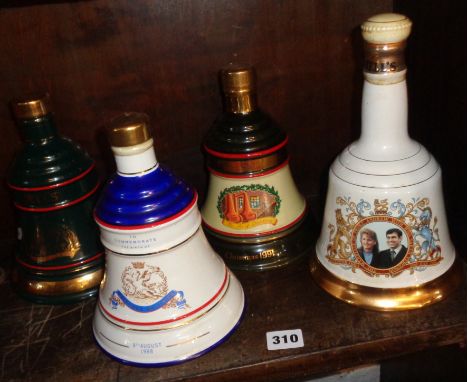 Four Wade china decanters full of Bell's Whisky