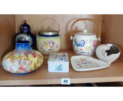 Four pieces of Poole Pottery, inc. biscuit barrel and three others
