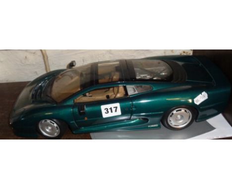 A Maisto 1/12 scale model of an XJ220 in green livery