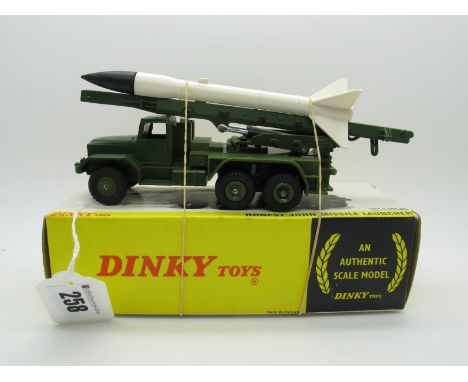 A Boxed Original Dinky #665 Honest John Missile Launcher, olive green body and platform, green plastic wheels. White missile 
