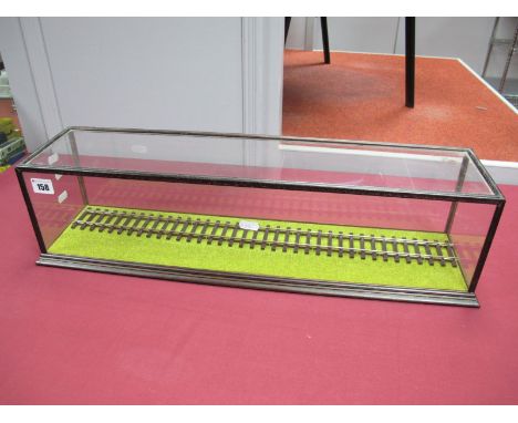 A Glass Display Case, ideal for 'O' gauge. with a piece of track, 61cms long/16cms tall.