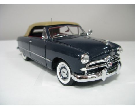 A Boxed Franklin Mint 1:24th Scale Die Cast 1949 Ford Custom Convertible, highly detailed model in dark blue with pink/beige 