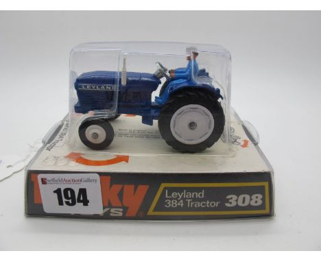 A Bubble Packed Original Dinky #308 Leyland 384 Tractor, dark blue body, white cast and plastic hubs, light blue driver. Mode