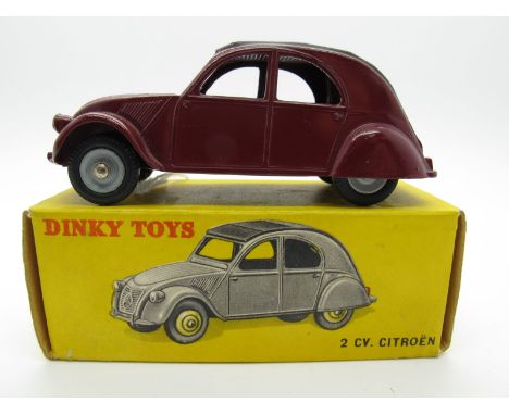 A Boxed Original French Dinky #535 Citroen 2 CV, maroon body, grey top, light grey painted convex hubs. Model is mint. Box ve
