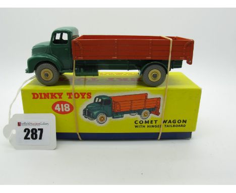 A Boxed Original Dinky #532 Leyland Comet Lorry, with hinged tailboard. Dark green cab and chassis, orange back, cream hubs, 