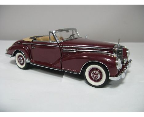 A Boxed Franklin Mint 1:24th Scale Die Cast 1957 Mercedes-Benz 300 SL, highly detailed model in maroon. Model in very good co