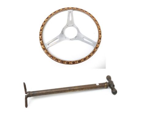 A 1950/60 Wood Rim and Rivetted Three-Spoke Steering Wheel, 40cm diameter; and An Early 20th Century Dunlop Brass Hand Pump, 