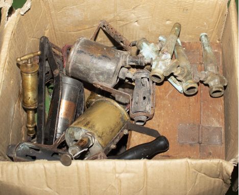A box containing vintage blow lamps and other metal items