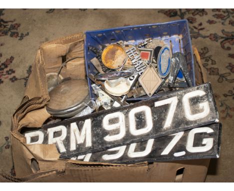 A pair of 1969 number plates together with a box of vintage car badges, lamps and lights
