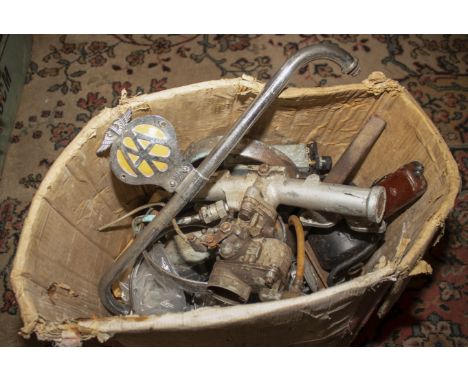 A box of assorted vintage car parts