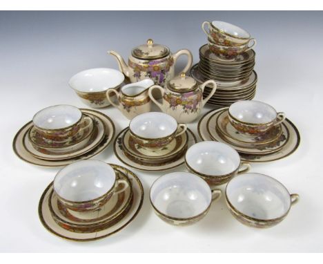 A Taisho / Showa Japanese porcelain tea service comprising tea pot, milk jug, sucrier and slops basin, six cups, ten saucers,