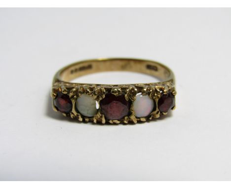 An opal and garnet ring, comprising three circular garnets divided by opal two cabochons scroll-set on a 9 ct gold shank
