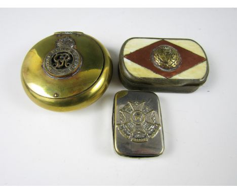 A George V brass pinch-action snuff box incorporating a cap badge of the Royal Horse Guards, together with a Victorian milita