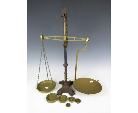 A set of Victorian brass and iron counter beam scales with weights, 60 cm high