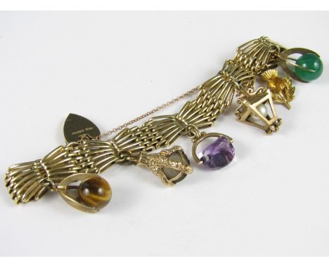 A 9ct gold charm bracelet, of fancy gate link form, with six dependant charms and padlock clasp, 32.4g