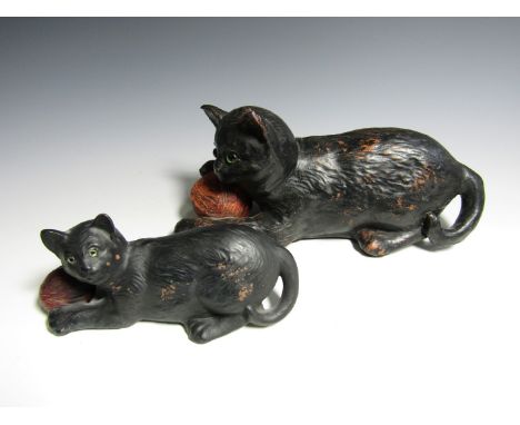 Two Bretby terracotta cats, modelled playing with a balls of wool