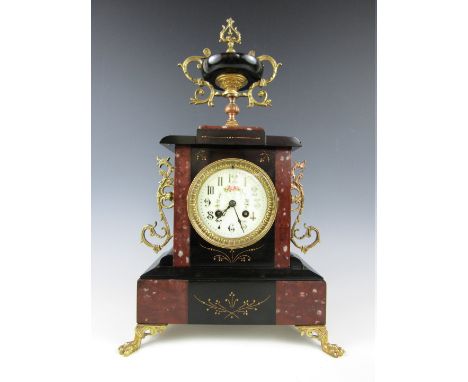 A late 19th Century gilt metal mounted marble mantel clock, the two-train movement by F Martin striking on a bell and having 