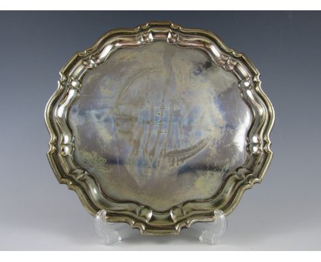 A George VI silver salver, having Chippendale border, bearing the engraved presentation inscription Mackinnon Mackenzie and C