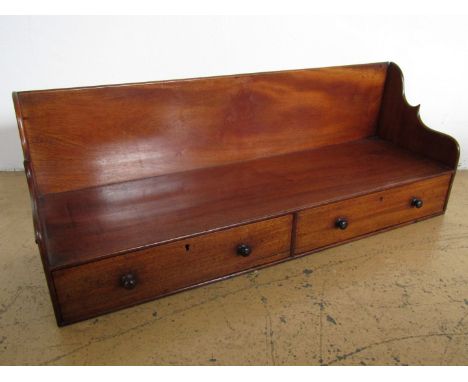 An early 19th Century mahogany shelf bracket incorporating a pair of drawers and wooden side handles, 76 cm x 28 cm high