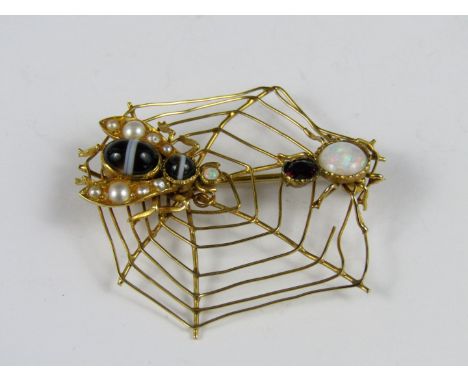 A novelty gem-set insect and cobweb brooch, modelled in the form of a garnet and opal spider chancing upon a pearl and agate 