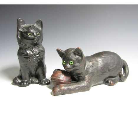Two Bretby terracotta cats, one modelled playing with a ball of wool, the other sat on its haunches 