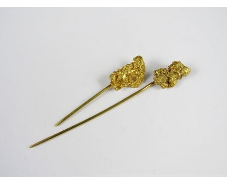 Two high carat yellow metal stick pins, each having a natural gold nugget terminal, 4.9 g