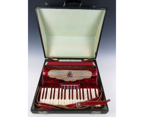 A vintage red lacquered Eufonica accordion with original case 