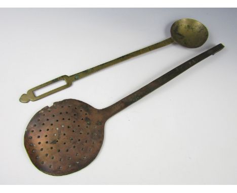 A copper round spatula, the bearing an engraved armorial crest and initials, together with a brass basting spoon, 18th -19th 