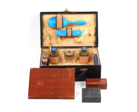 A small black leather travelling case with silver fittings, stamped in gilt 'The Goldsmiths And Silversmiths Company Ltd.', t