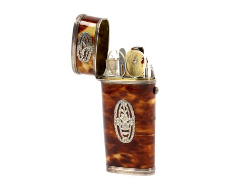 A late 18th Century tortoiseshell and silver mounted travelling etui, of oval section and tapering form, the side with four a