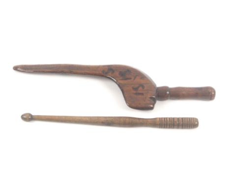 Two knitting sticks, comprising a well worn fruitwood goose wing example branded numerous times 'SI', 27cms, and a turned dru