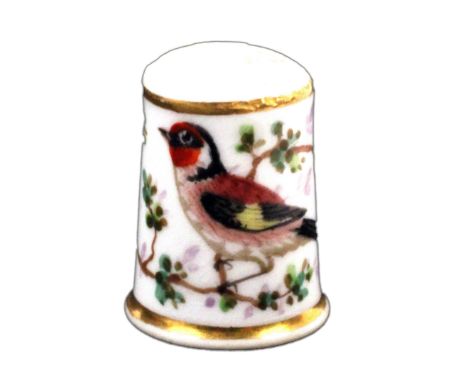 A 19th Century English porcelain thimble, of tall form, probably Worcester, painted with a brightly plumaged bird amid flower