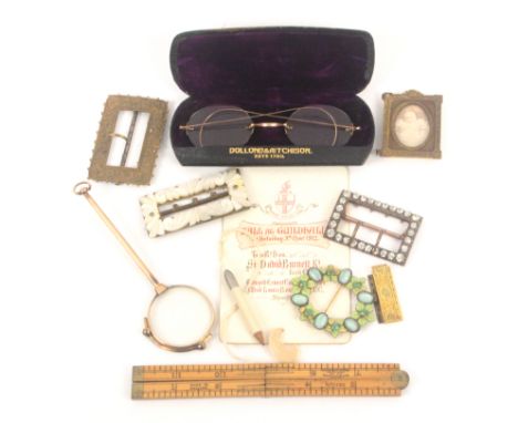 A mixed lot, comprising a gilt metal lorgnette, 13cms, cased spectacles, five various buckles, miniature gilt frame, steel wa