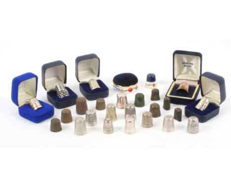 A collection of thimbles and related pieces, comprising nine excavated examples, two cased modern silver thimbles, four cased