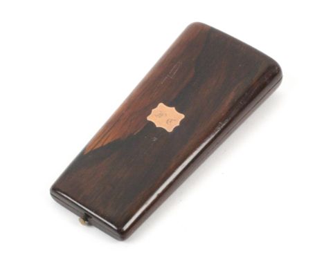 A French rosewood etui, circa 1820, of near oval section and tapering form, the lid with an initialled gold plaque. The rosew