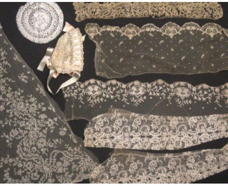 A collection of lace and linen, comprising a lace shawl and other pieces, three bonnets, and two table cloths.&nbsp; &nbsp; &
