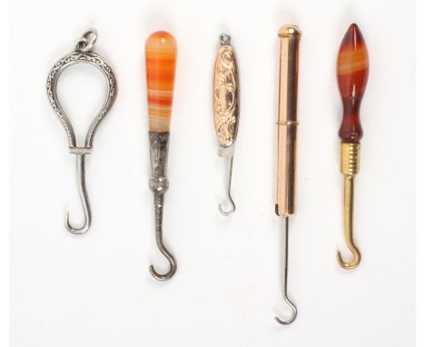 Miniature button hooks, comprising a folding example with unmarked gold leaf scroll handle, 4.7cms, another in gold coloured 