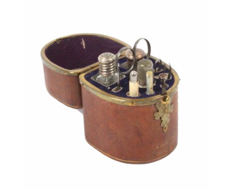 A French sewing etui, circa 1880, of near semi circular form and covered in reeded and gilt tooled brown leather titled in gi