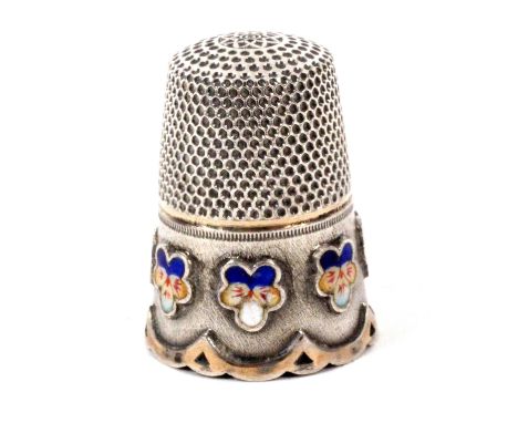 An attractive and unusual cased English silver thimble, unmarked, the frosted frieze with six raised enamel pansy heads encir