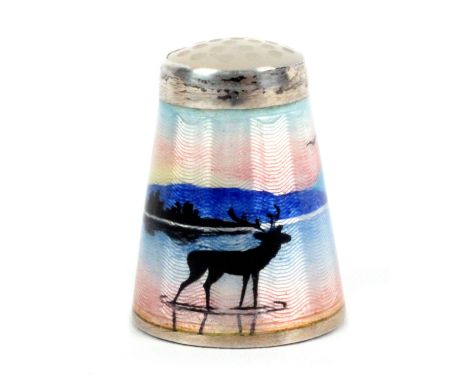 A Norwegian silver gilt and enamel moonstone top thimble by Nils Elvik, depicting a stag in a mountainous lake and wooded lan