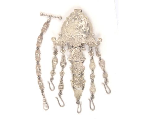 A continental silver chatelaine and a watch chain, the first with elaborate hook mount cast with love birds and torcheres wit