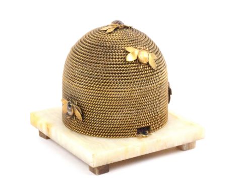 A gilt metal bee skep sewing box attributed to George Betjemanns and Sons, circa 1870, on a square onyx base raised on block 