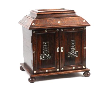 A rosewood and mother of pearl inlaid table cabinet fitted for sewing, jewellery and writing, circa 1850, the rectangular bas