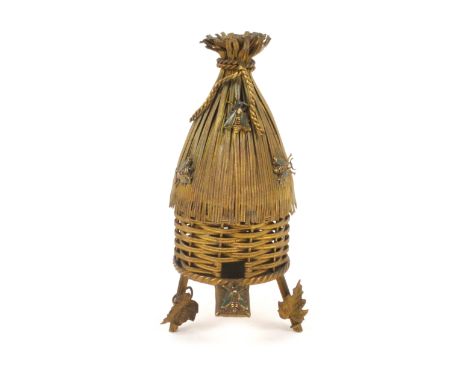 A French gilt metal etui for a child, circa 1880, in the form of a bee skep, raised on three legs, the front two with leaf mo