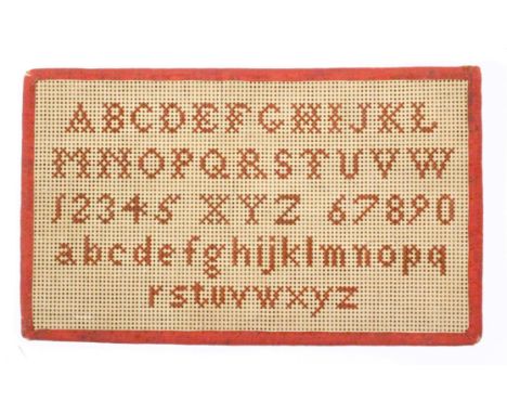 A simple Bristol card rectangular sampler, upper and lower case alphabets numerals 1-9 and 0, ribbon edge, 11.7 x 7cms.&nbsp;